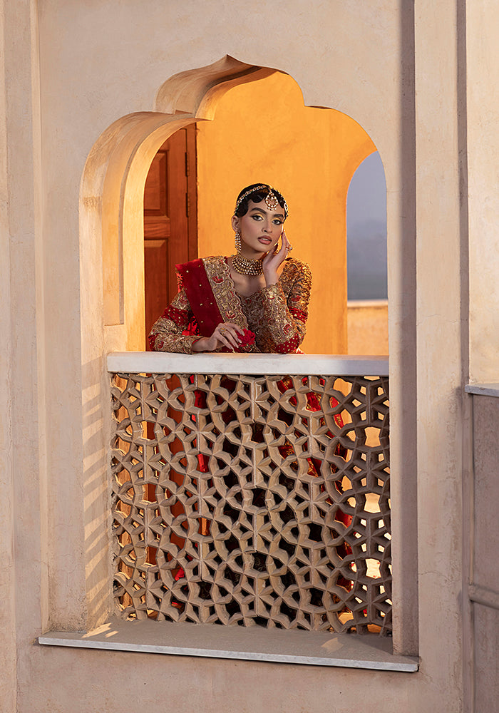 A bride framed in a carved lattice window