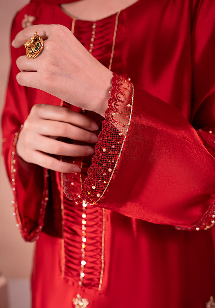 A scalloped net cuff finished with sequins